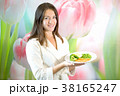 Young woman is holding plate of boiled vegetables 38165247