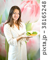 Young woman is holding plate of boiled vegetables 38165248