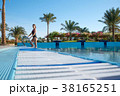 Woman comes out of the pool in beautiful swimsuit 38165251