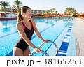 Woman comes out of the sports pool in swimsuit. 38165253