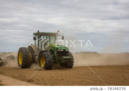 Huge tractor removes the field from the remains of 38166256