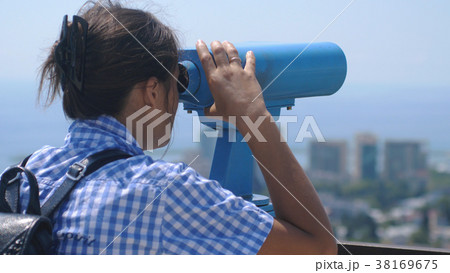 Tourist looking through binoculars at Sochi. Young Tourist looking through binoculars at Sochi. Young 38169675