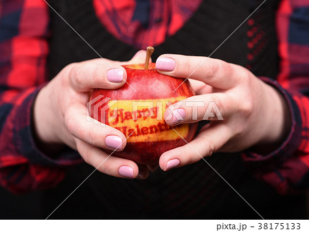 Female hands with an apple. Valentine's Day. 38175133