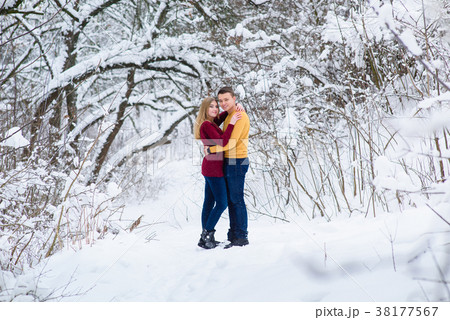 Young couple hug in winter forest 38177567