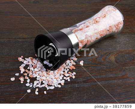 Glass saltcellar with salt on wood Glass saltcellar with salt on wood 38177859