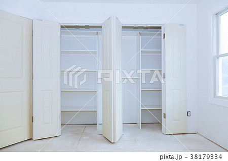 With a shelf near of big cabinet. 38179334