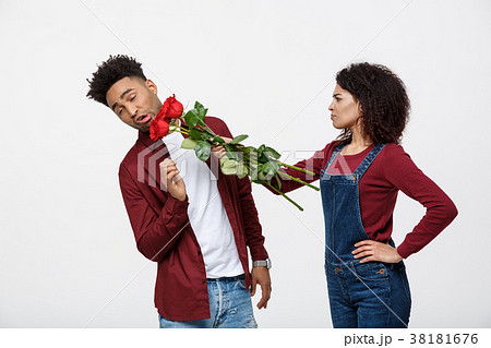 Portrait of a disappointed young woman holding red 38181676