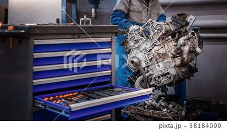 overhaul repair. The young auto mechanic 38184099