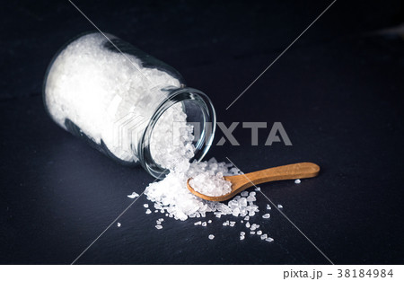 Sea salt with spoon and jar on dark background 38184984