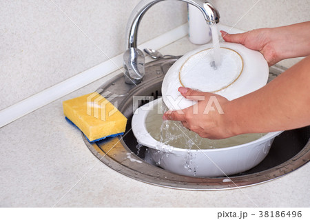 women hends washing dishes in the kitchen ,close 38186496