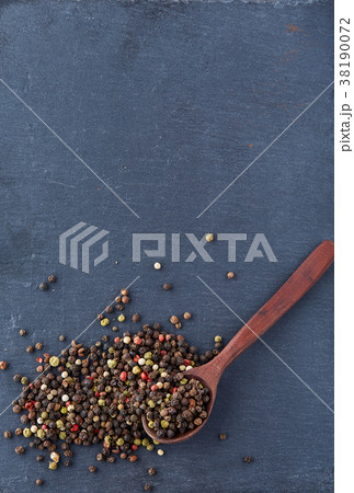 black pepper peas in a spoon on a stone background black pepper peas in a spoon on a stone background 38190072