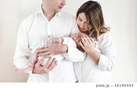 Young happy parents with newborn baby daughter Young happy parents with newborn baby daughter 38190493