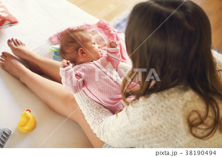 Young mother holding her newborn child. Young mother holding her newborn child. 38190494