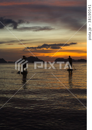two man silhouette standing on sup boards on 38190541