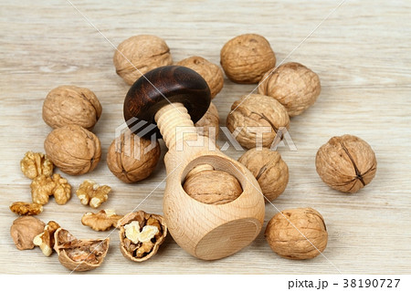 Wooden nutcracker in a mushroom shape and walnuts 38190727