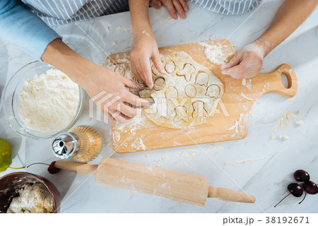 Happy family making cookies together 38192671