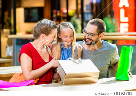 Family having break from shopping in mall Family having break from shopping in mall 38192789