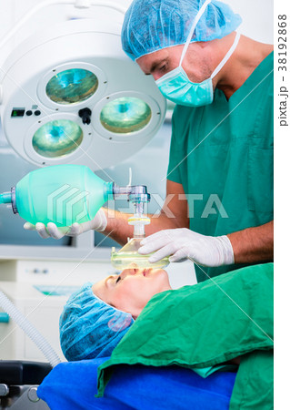 Doctor surgeon with patient in operating room Doctor surgeon with patient in operating room 38192868
