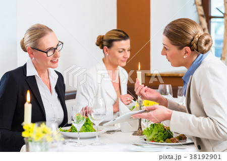 Businesswomen meeting at business dinner 38192901