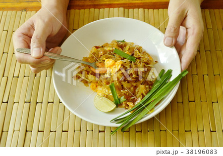 fork scooping Pad Thai stir fried rice noodles  38196083