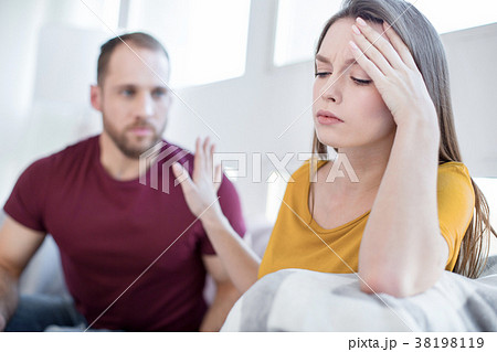Unsmiling woman not wanting to talk with her man 38198119