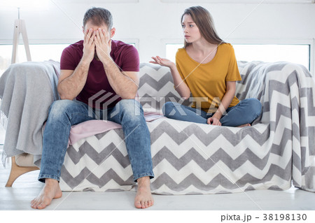 Unhappy woman talking to her man about his Unhappy woman talking to her man about his 38198130