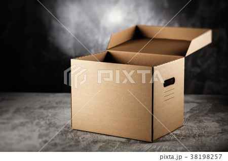 Cardboard box on grey background Cardboard box on grey background 38198257
