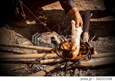 Chef burnt the pork leg in a charcoal stove. Chef burnt the pork leg in a charcoal stove. 38203588