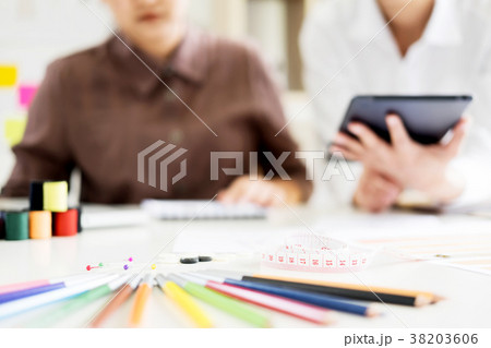 two young men working as fashion designers and drawing sketches 38203606
