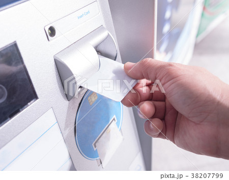 Hand inserting card into automatic teller machine Hand inserting card into automatic teller machine 38207799