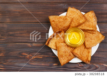 Pancakes with honey and butter on a wooden 38208518