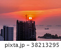Construction crane and skyscraper in the sunset. 38213295