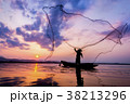 Asian fisherman on wooden boat casting a net for c 38213296