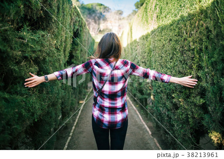 Young woman walking in the park labyrinth 38213961
