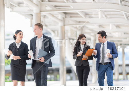 Businesspeople Talking to each other while walking 38217104