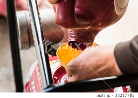 Farmer fill fuel into self-priming water pump 38217785