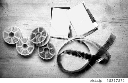 Old photoghraphic film on wood background Old photoghraphic film on wood background 38217872