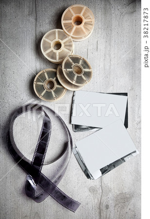 Old photoghraphic film on wood background  38217873