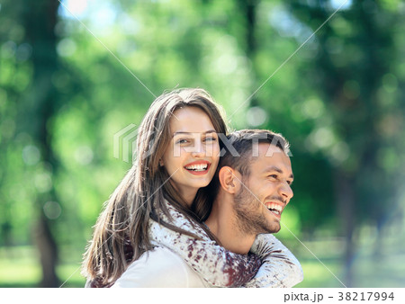 Outdoors portrait of lovers happy young man and woman 38217994