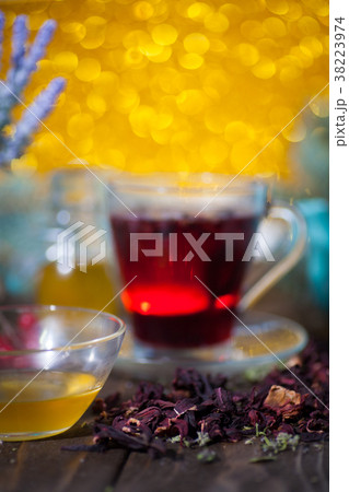 Hibiscus tea in a glass cup on a wooden background Hibiscus tea in a glass cup on a wooden background 38223974