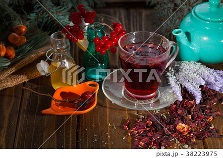 Hibiscus tea in a glass cup on a wooden background 38223975