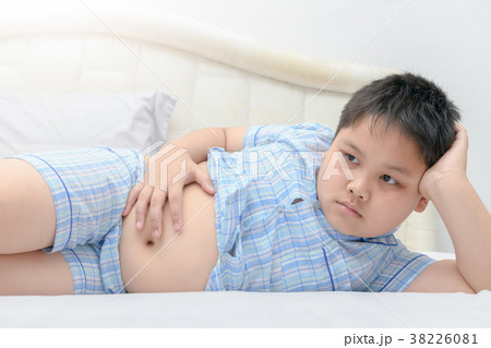 Obese fat boy lying show stomach on bed Obese fat boy lying show stomach on bed 38226081
