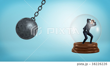 A small businessman stands inside a glass sphere A small businessman stands inside a glass sphere 38226226