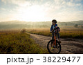 Boy rides a bicycle in the sunrise 38229477