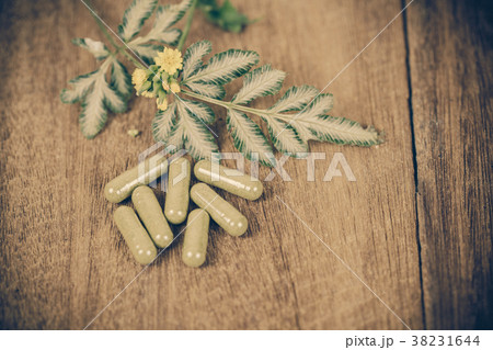 Herbal medicine capsules from herb on rustic wood Herbal medicine capsules from herb on rustic wood 38231644