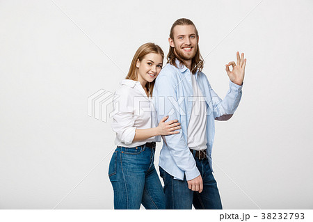Happy young couple doing Ok gesture, isolated on Happy young couple doing Ok gesture, isolated on 38232793