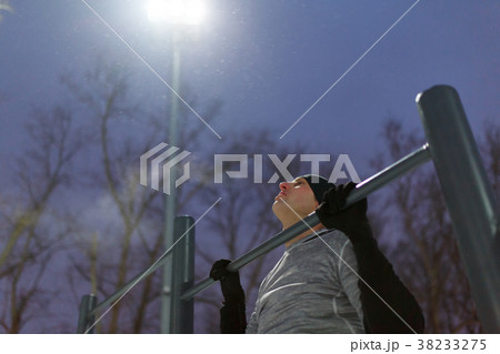 Picture of sports man pulling up on bar in evening Picture of sports man pulling up on bar in evening 38233275