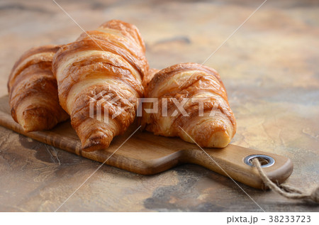 Fresh Croissants on a Wooden Cutting Board. 38233723