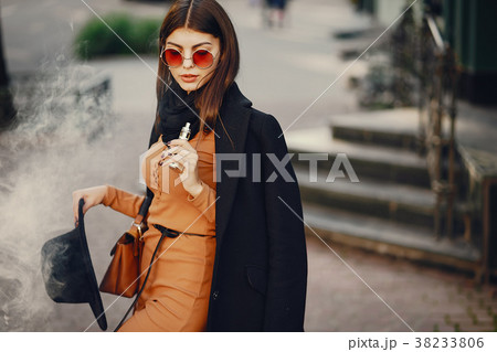 stylish girl smoking an e-cigarette 38233806