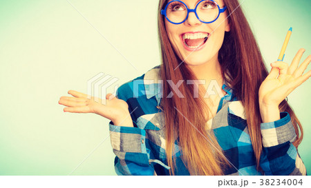 Happy nerdy woman in glasses holding pen 38234004